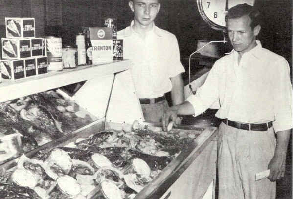 R. W. and H. Stanley Goff inspect a display to tempt the appetites of sea food lovers.; Photo from The Delaware County Advocate, July 1942